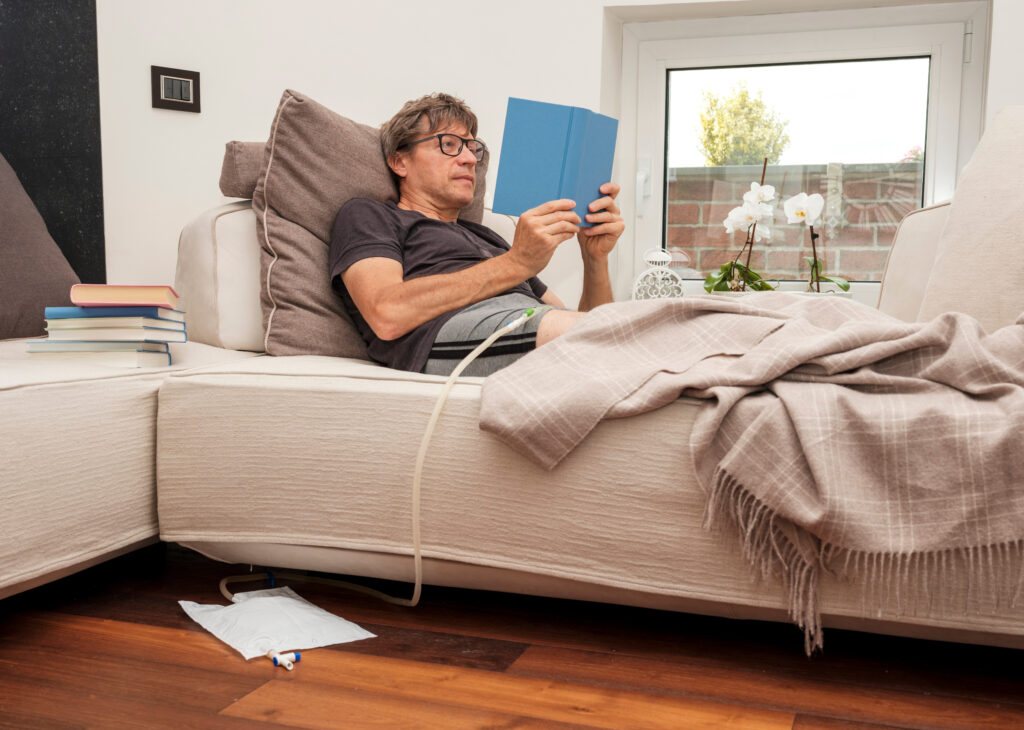 patient with urethral catheter inserted into the penis, including bag and flexible tube.